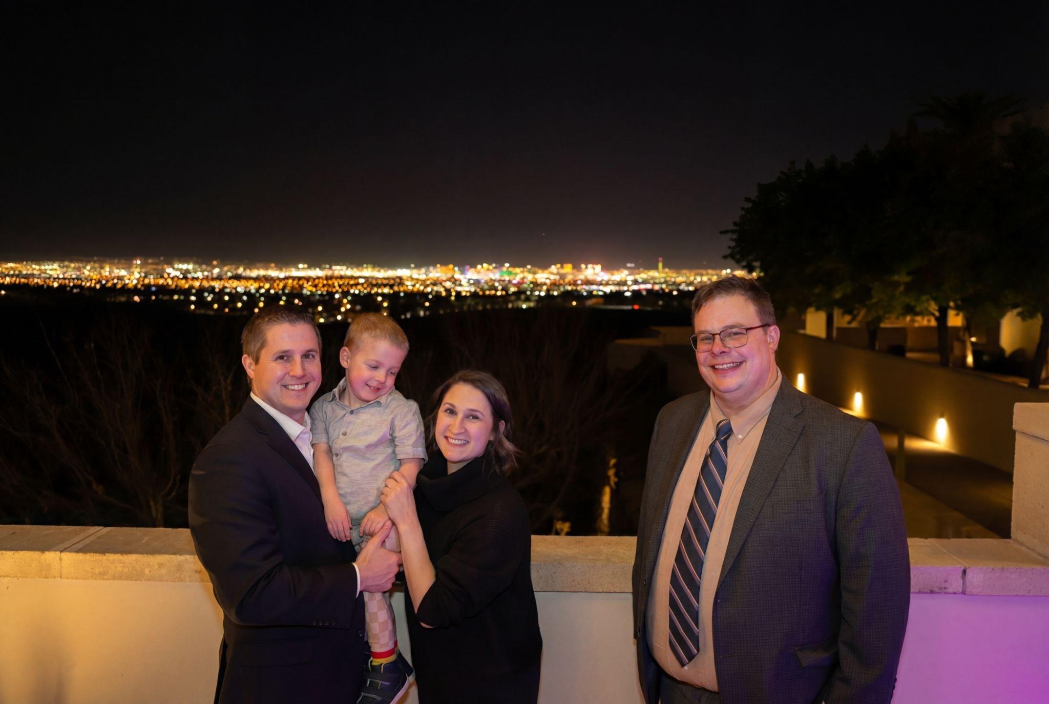 Jordan, Jen, and Liam Mitchell with Dr. Mark Schultz overlooking the Las Vegas valley at night